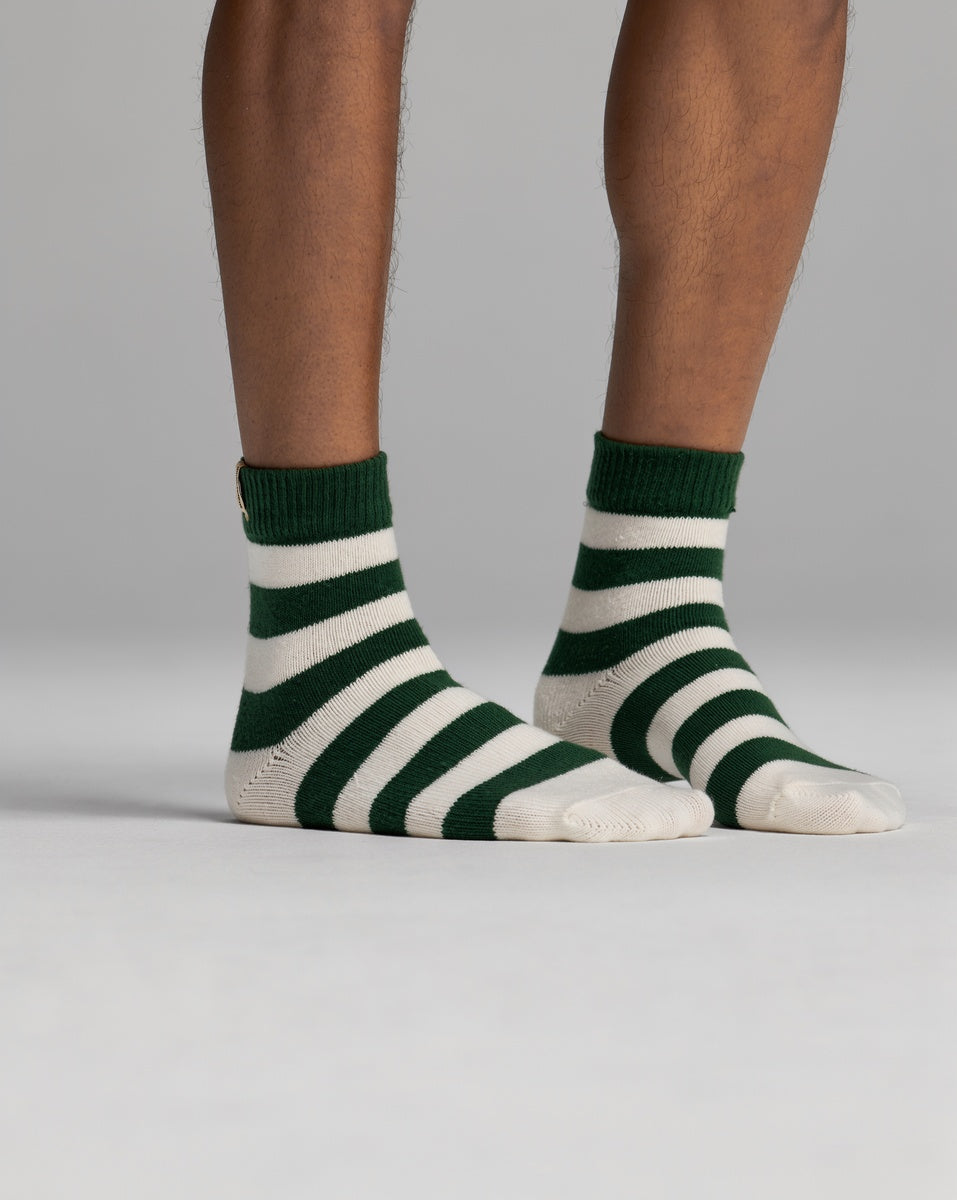 A pair of Cozy Earth Women’s Plush Lounge Quarter ankle socks with green and white horizontal stripes.