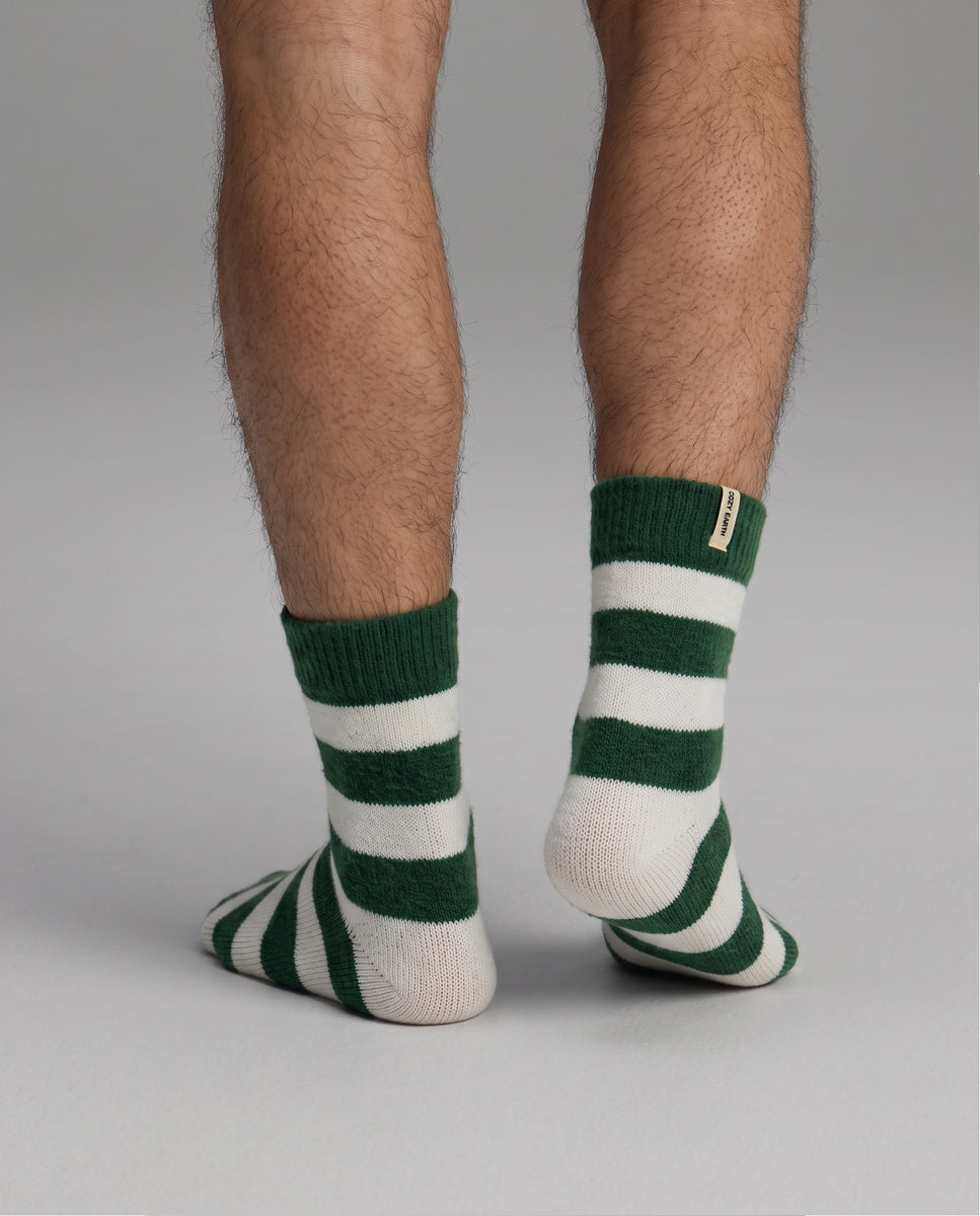 Lower legs wearing Women’s Plush Lounge Quarter Sock featuring thick white and dark green horizontal stripes.