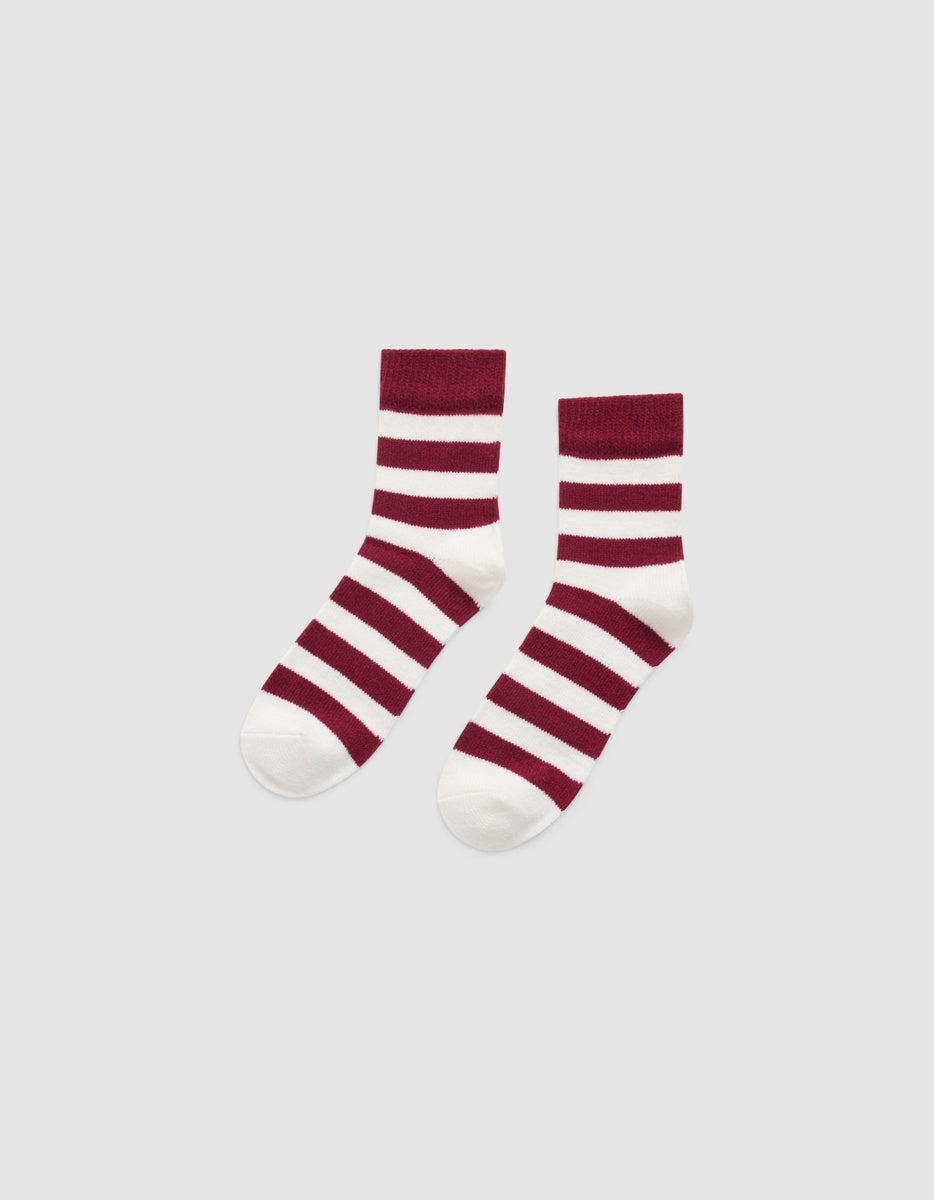 A pair of Cozy Earth Women’s Plush Lounge Quarter socks with maroon and white horizontal stripes.