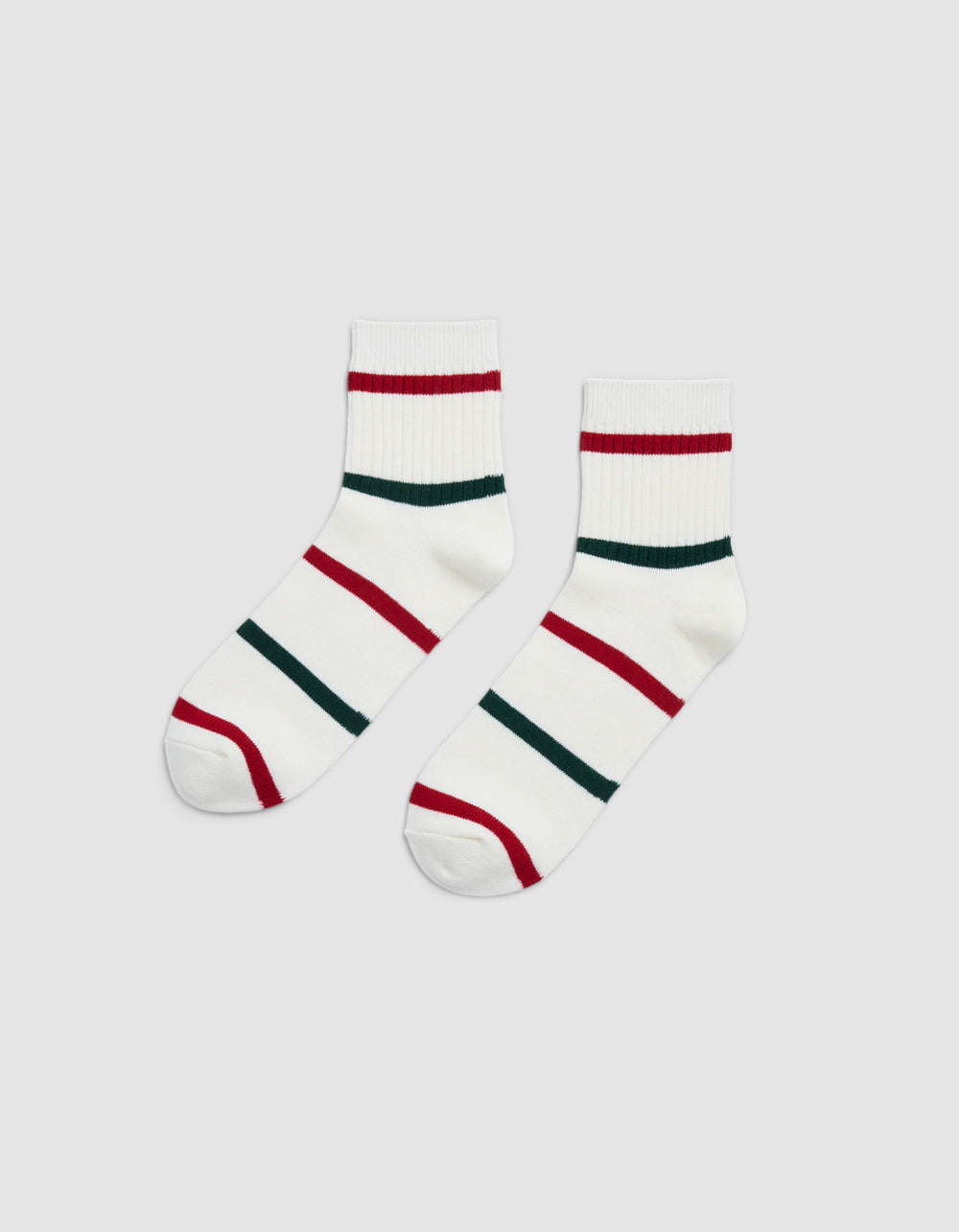 The Women's Sadie Sock by Cozy Earth is shown side by side on a light gray background, featuring white ankle-length design with red and green horizontal stripes.|Color:Jade/Crimson