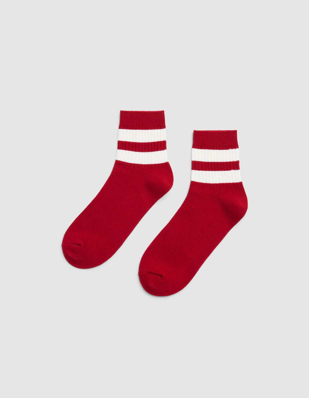 A pair of Cozy Earth Women's Sadie Socks in Crimson/Bone, featuring two thick white stripes by the cuffs, displayed side by side on a plain light gray background.