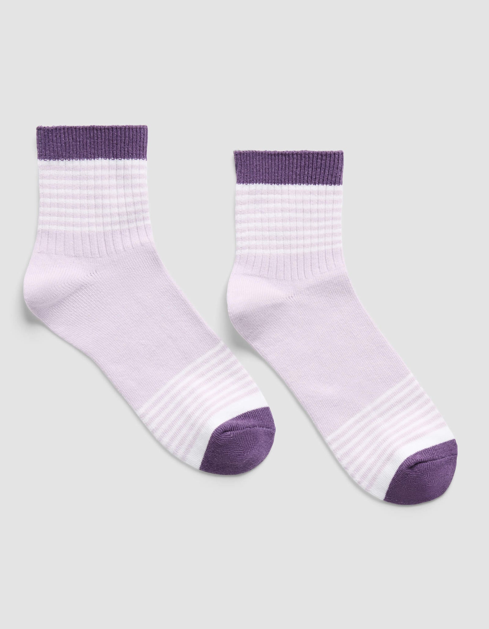The Women's Sadie Sock by Cozy Earth, in light purple with darker purple toes, heels, and ribbed cuffs, is shown on a plain light gray background.