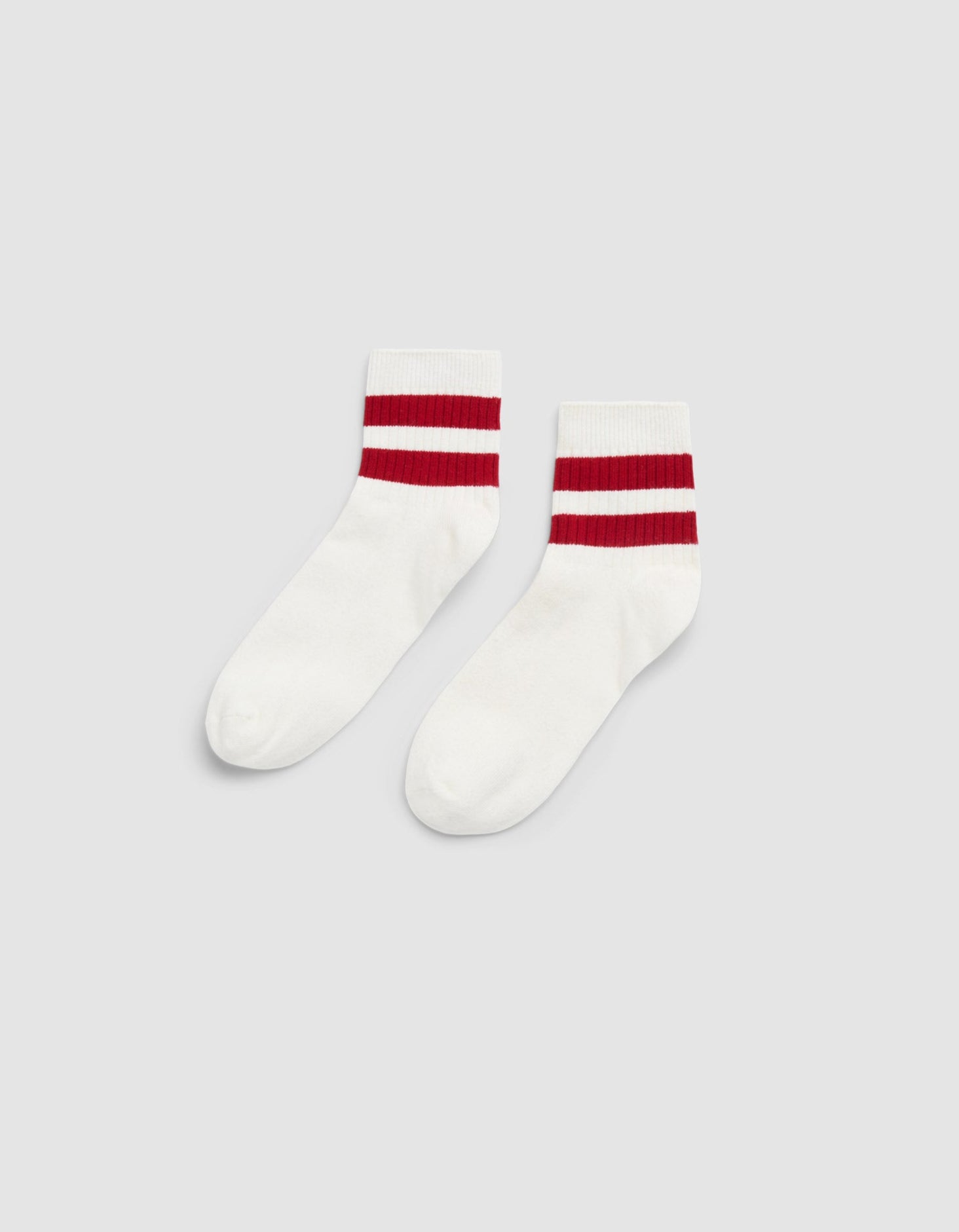 The Women's Sadie Sock by Cozy Earth is a white crew sock with two thick red stripes near the top, shown on a plain light gray background. |Color:Bone/Crimson