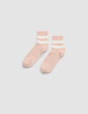 The Women's Sadie Sock by Cozy Earth features light pink fabric with two white and one beige horizontal stripes near the cuffs, shown on a light gray background.  |Color:Dusty Rose/Bone
