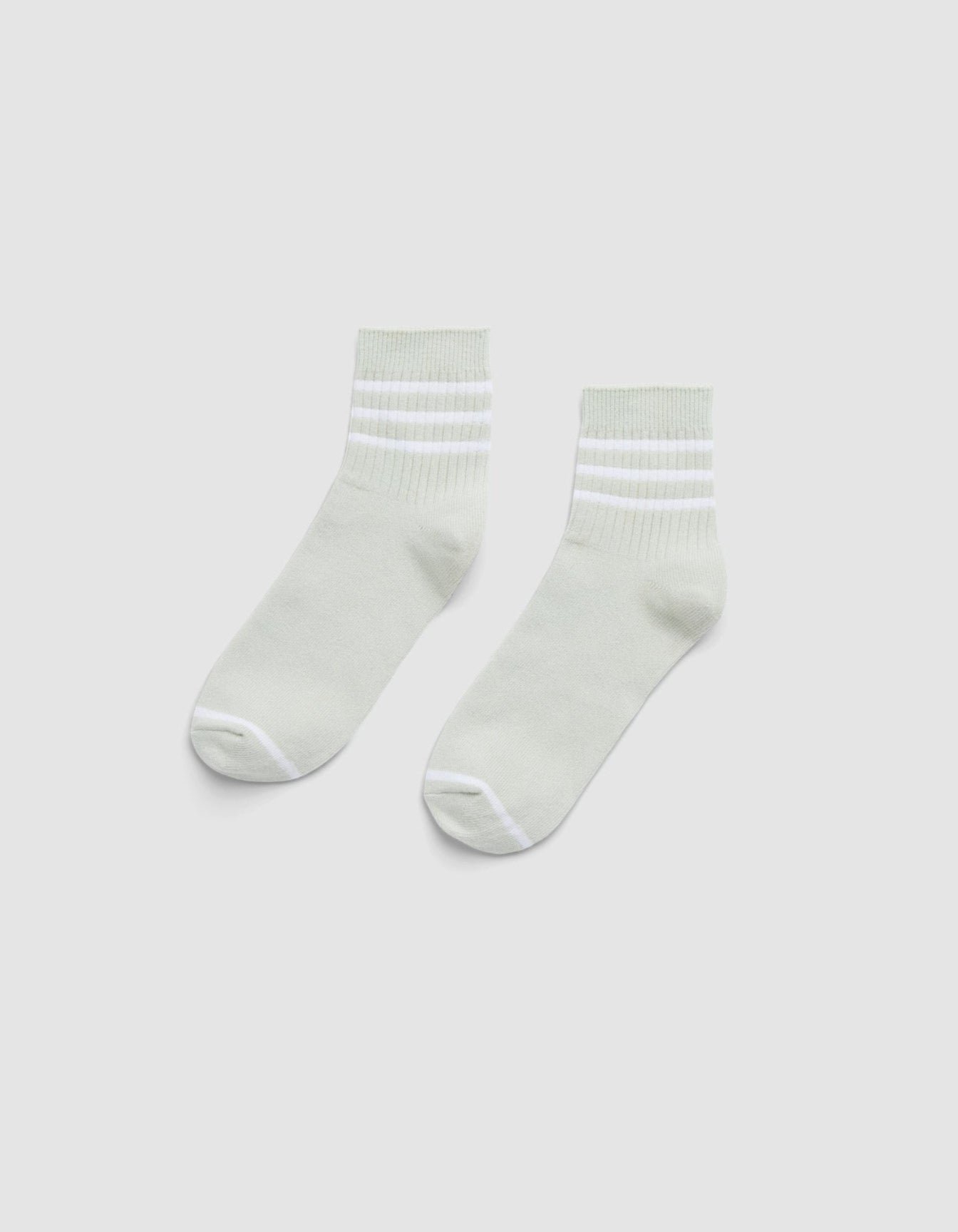 The Cozy Earth Women's Sadie Sock is a pair of light gray ankle socks with white toes, heels, and two white stripes near the cuffs, shown laid flat on a plain white background. 