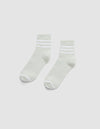 The Cozy Earth Women's Sadie Sock is a pair of light gray ankle socks with white toes, heels, and two white stripes near the cuffs, shown laid flat on a plain white background. |Color:Laurel/White
