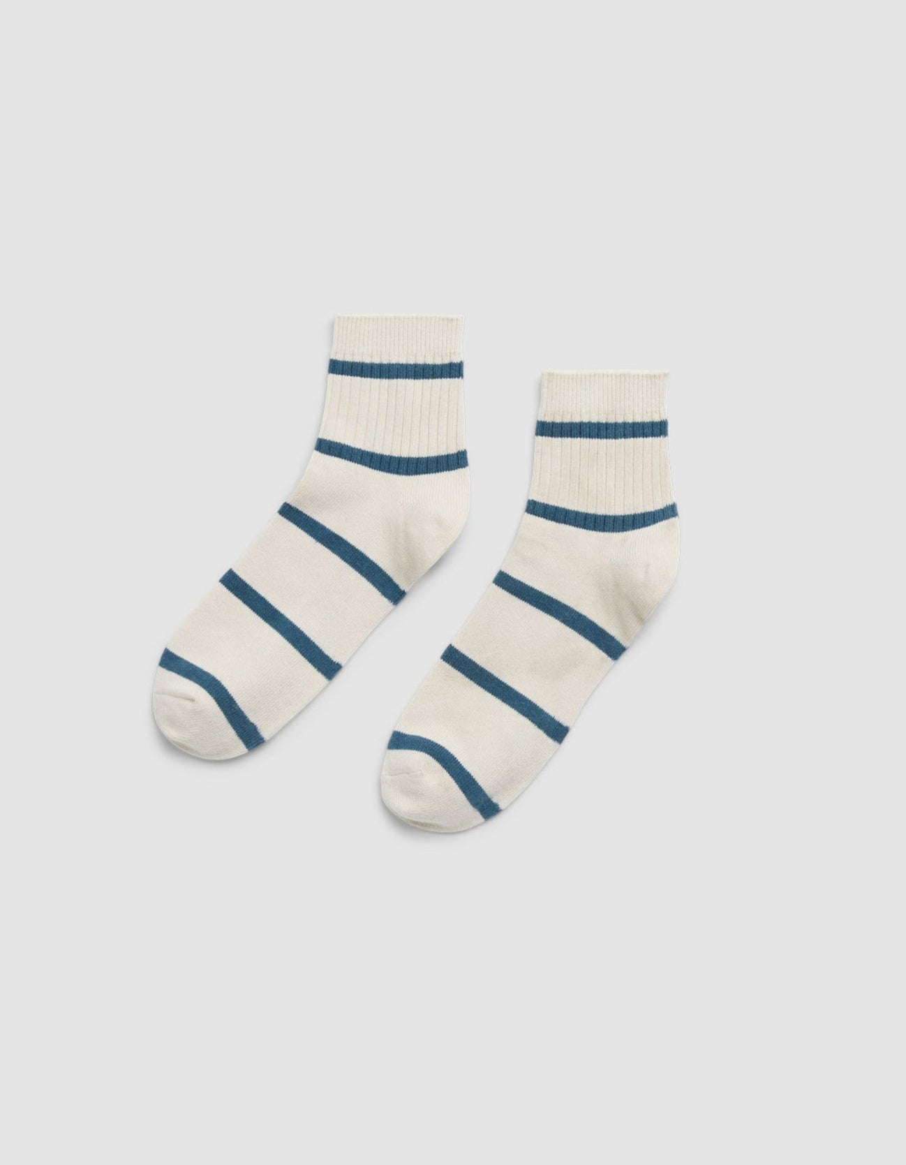 Cozy Earth Women's Sadie Sock: white ankle socks with horizontal blue stripes, shown side by side on a plain light gray background. 