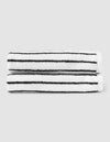 Two Cozy Earth Striped Luxe Hand Towels with black horizontal stripes are neatly stacked against a plain light gray background. |Color:Black Stripe