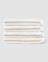 Four Cozy Earth Striped Luxe Washcloths, featuring white fabric with light beige stripes, are stacked neatly against a plain light gray background. |Color:Sand Stripe