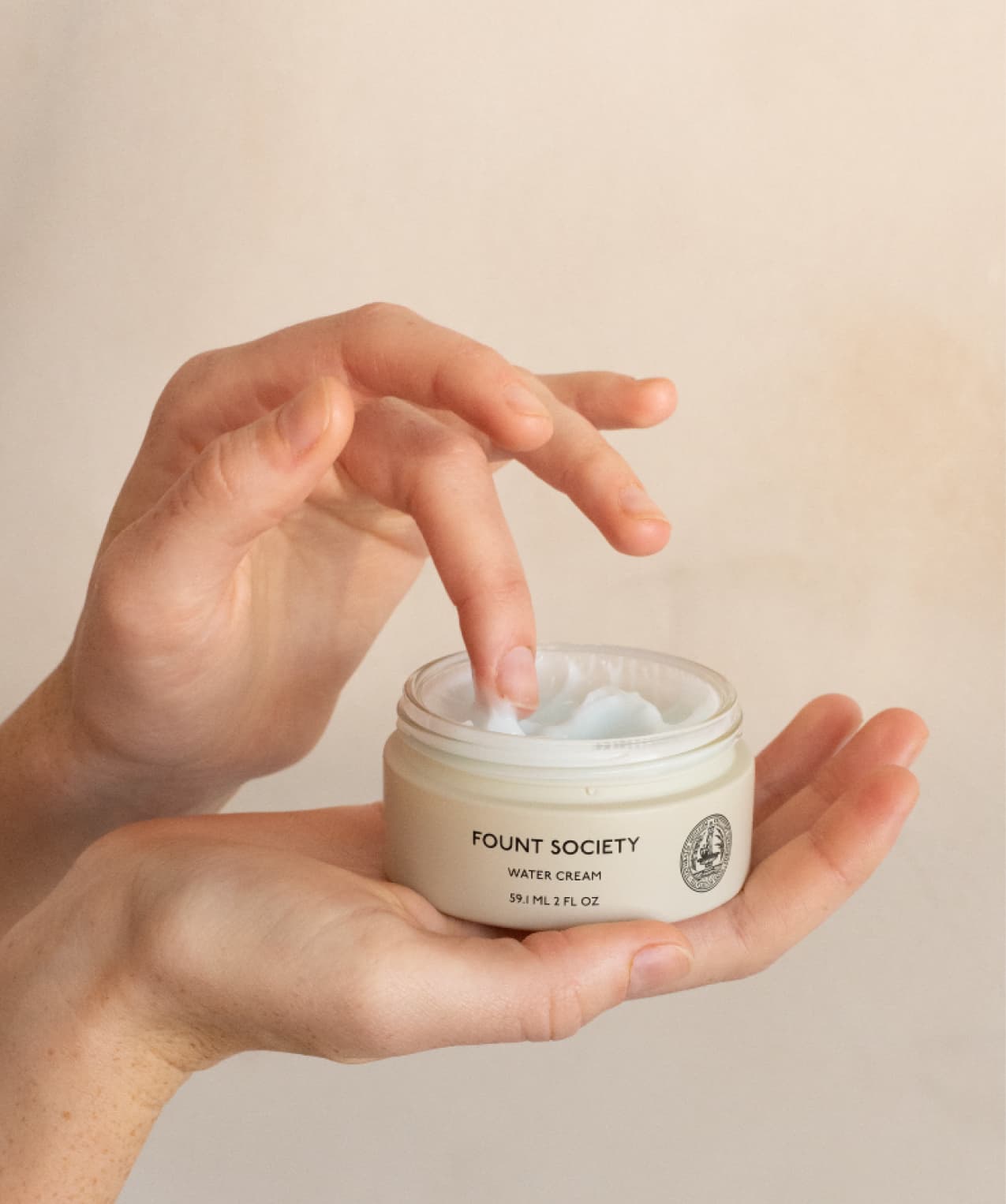 Hand holding Fount Society Water Cream 