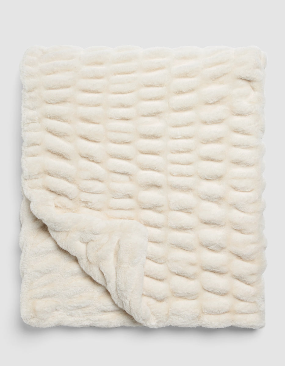 Off-white textured Snuggle Cuddle Blanket with a repeating grid of raised, rounded tufts.