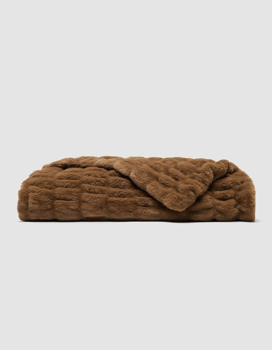 A folded brown Snuggle Cuddle Blanket with a textured, plush surface.