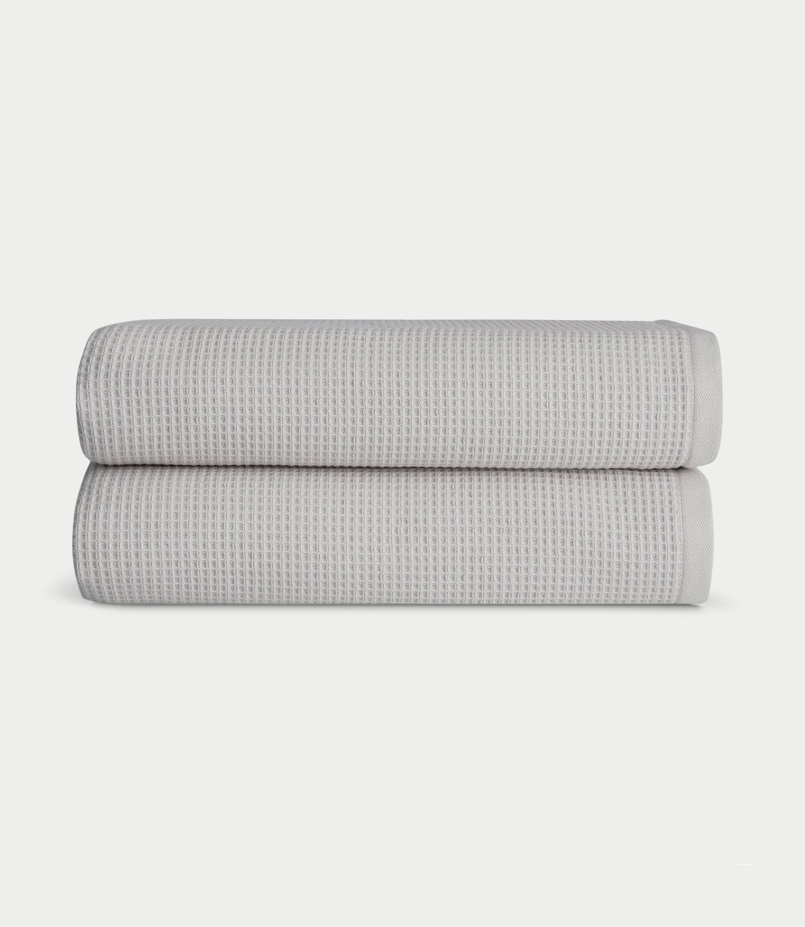 Waffle Bath towels in the color light grey. Photo of light grey Waffle Bath towels taken with white background. 