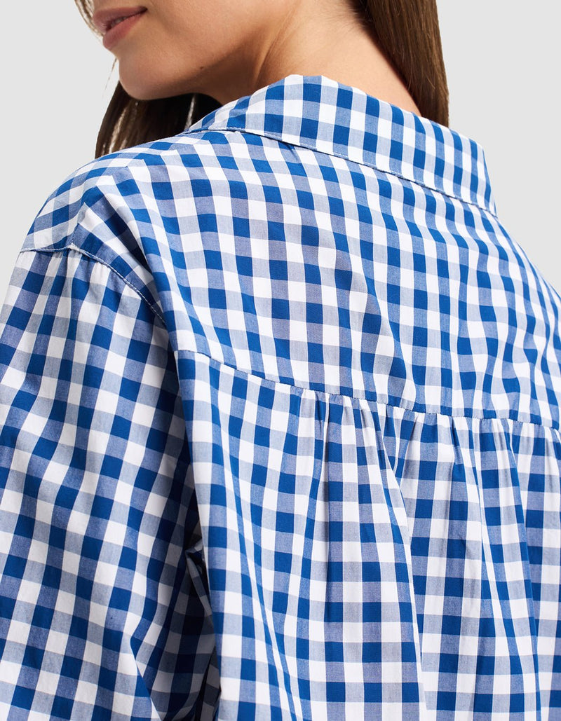 Close-up of a woman in profile wearing the Cozy Earth Women's Sutton Sleep Dress, highlighting the blue and white checkered fabric pattern, collar detail, and upper back.
