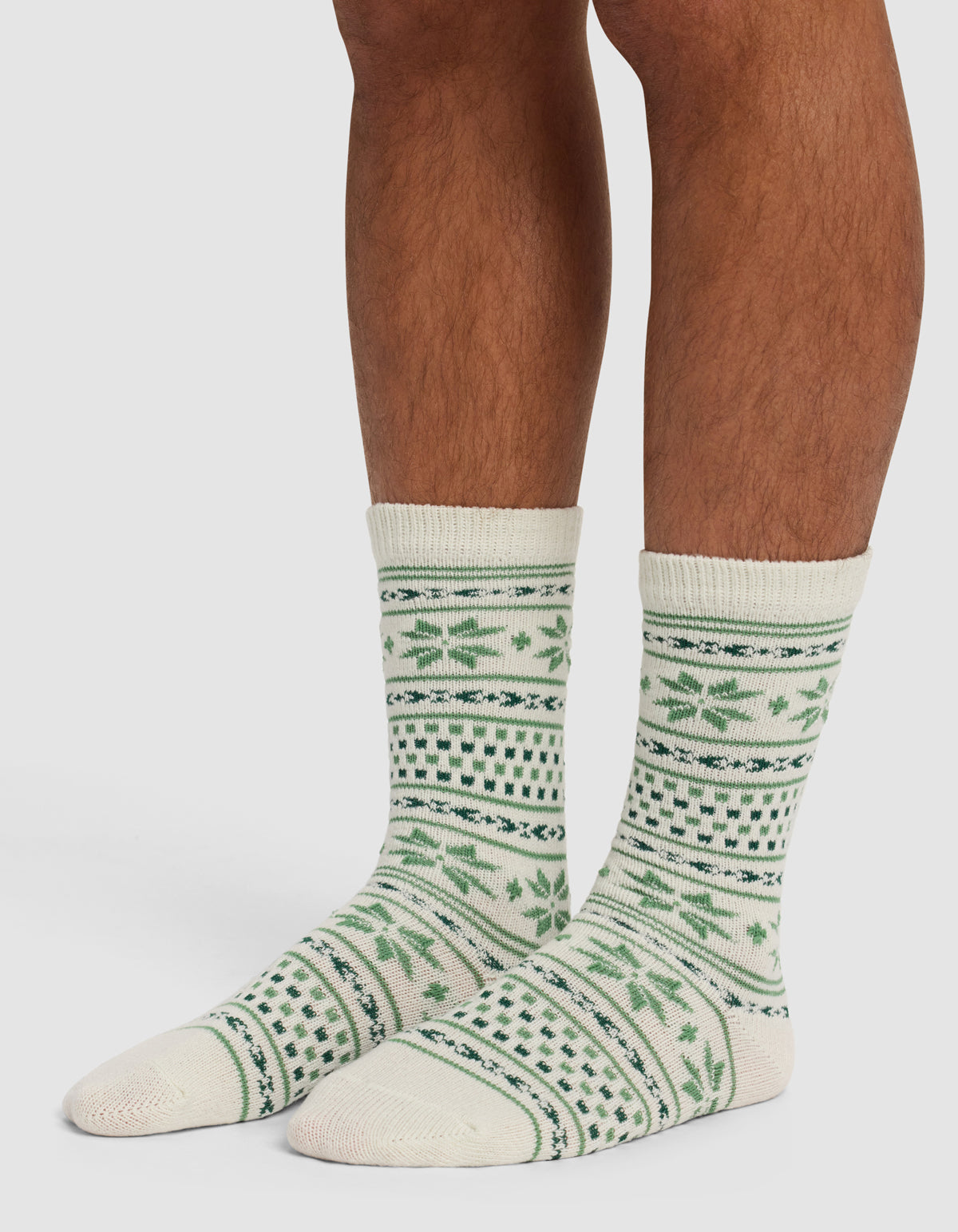 A person wearing The Snowflake Plush Lounge Sock by Cozy Earth.