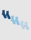 Four pairs of Cozy Earth’s The Plush Modern Crew Sock, in gradient blue shades from dark to very light, are arranged diagonally on a plain light background.|Color:Pacific/Harbor/Lake