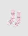 The Snowflake Plush Lounge Sock by Cozy Earth is a pair of pink crew socks with pink, purple, and white horizontal stripes and floral motifs, displayed on a light gray background.|Color:Ballet