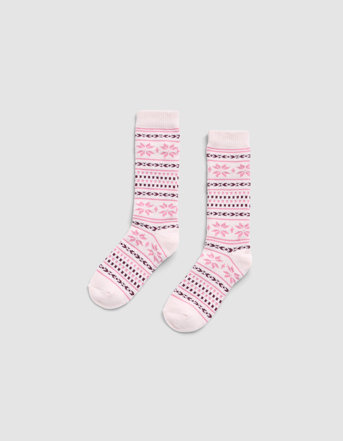 The Snowflake Plush Lounge Sock by Cozy Earth is a pair of pink crew socks with pink, purple, and white horizontal stripes and floral motifs, displayed on a light gray background.