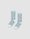 The Cozy Earth Snowflake Plush Lounge Sock features light blue fabric with dark blue geometric and snowflake stripes, shown on a plain light gray background.|Color:Mist