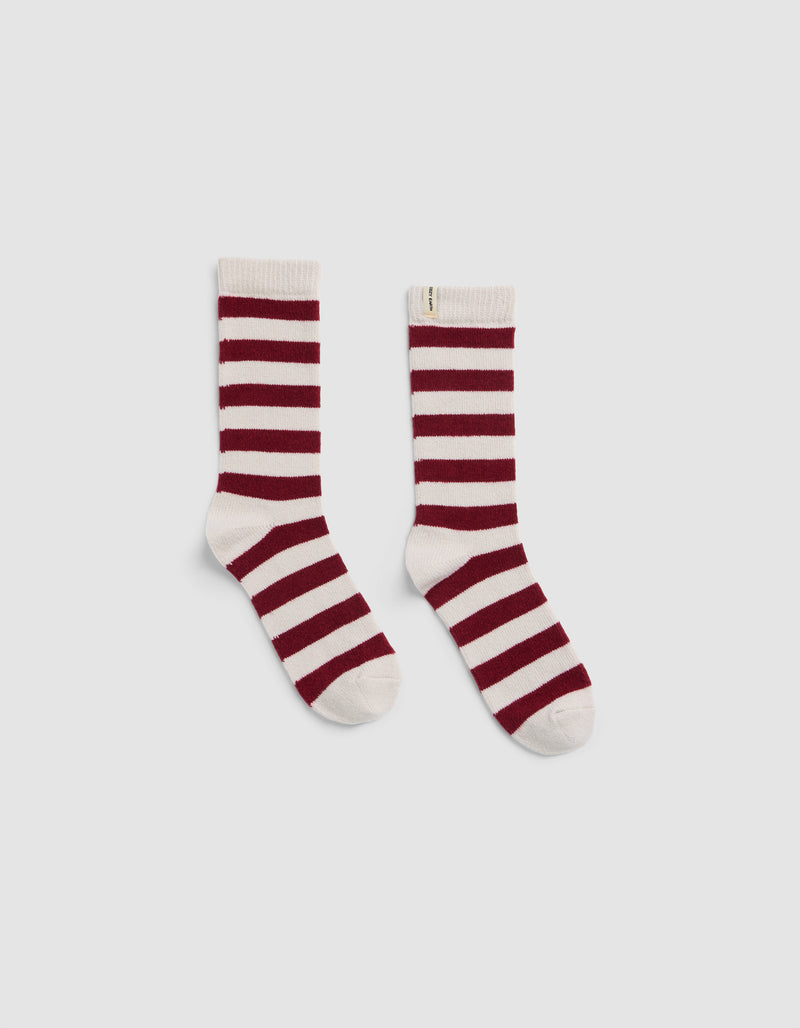 The Plush Modern Crew Sock by Cozy Earth, featuring horizontal maroon and white stripes, is shown crew-length and displayed flat on a light gray background.