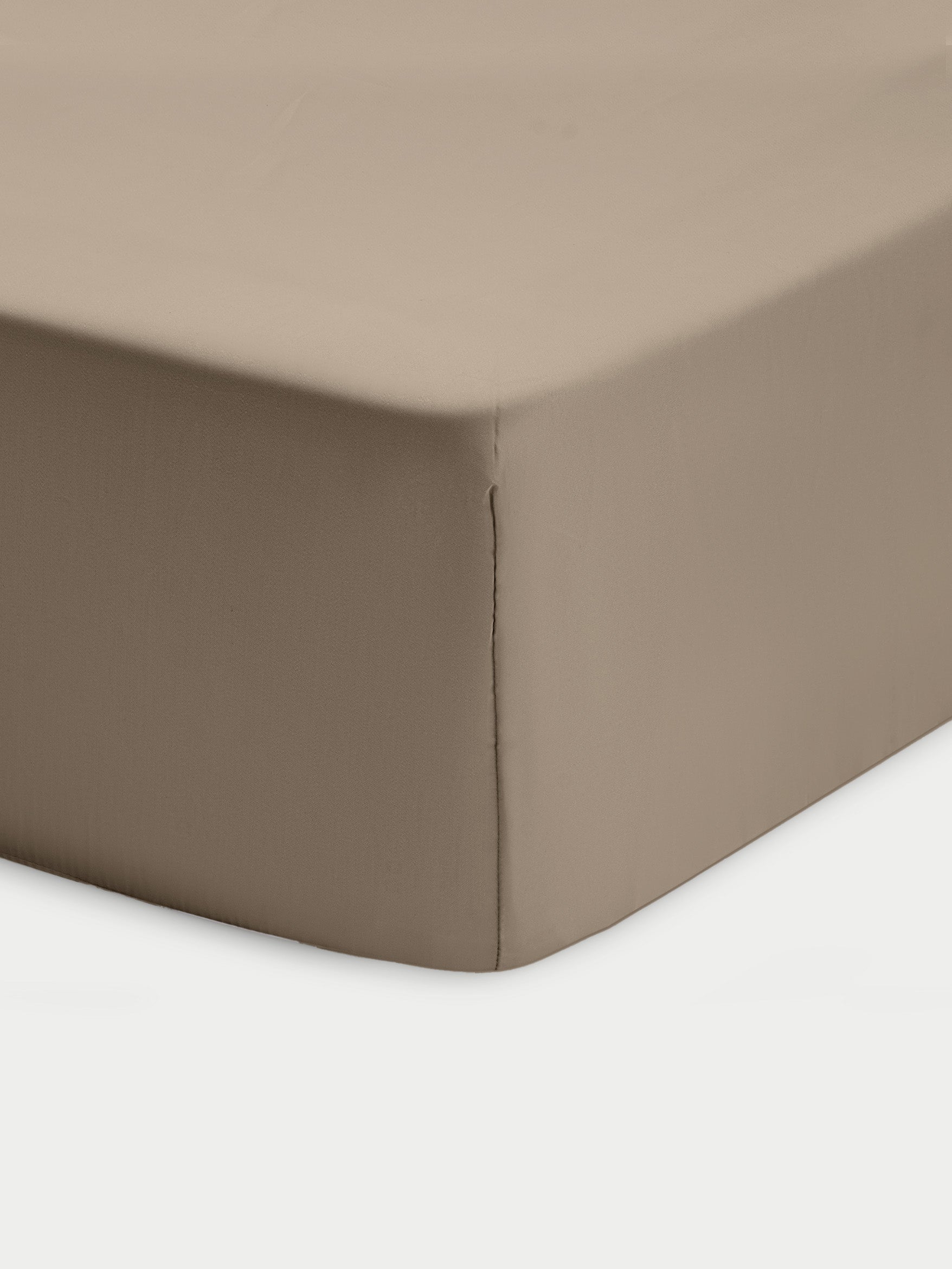 Corner of walnut crib sheet with white background 