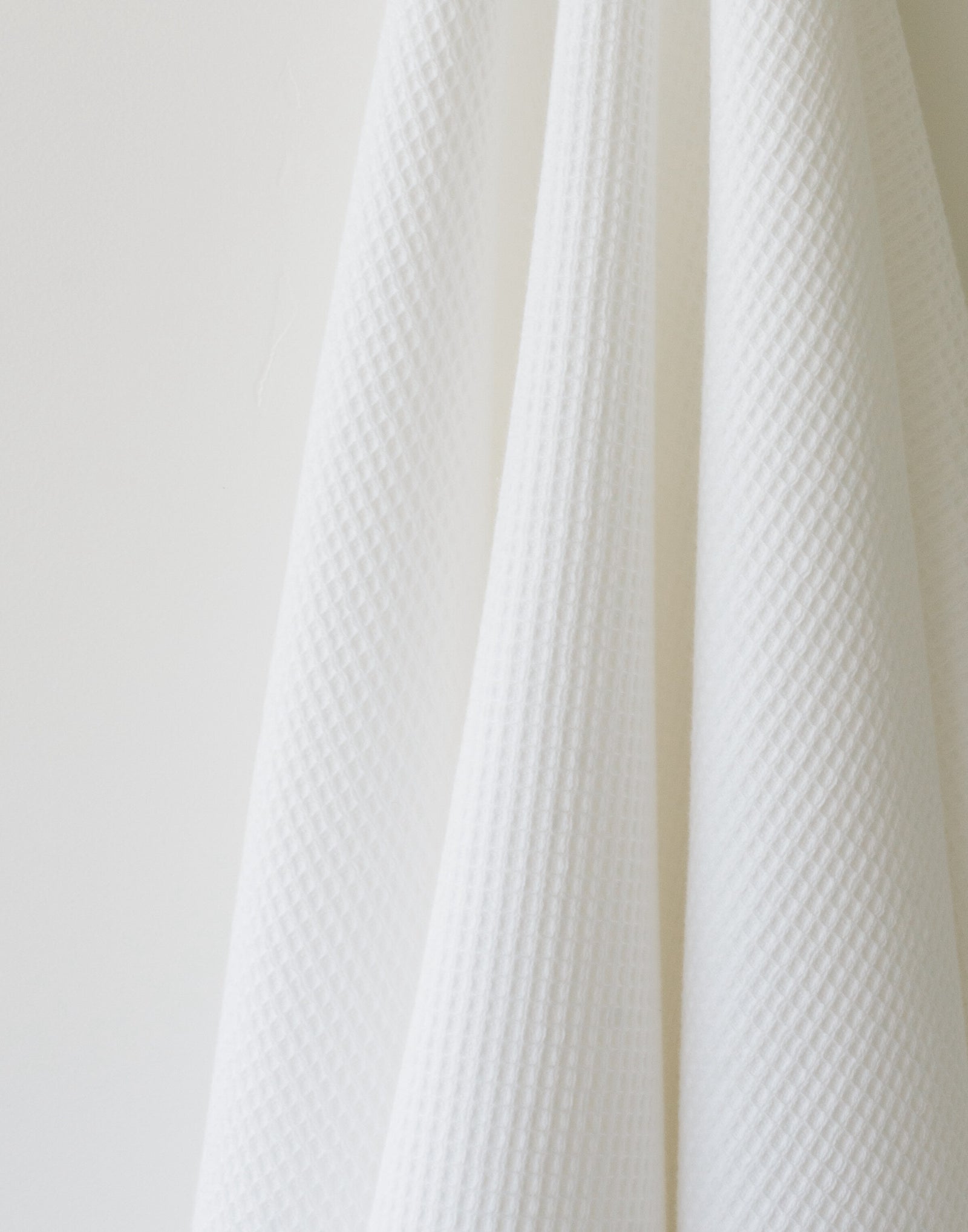 Waffle Bath Towel in the color White. Photo of White Waffle Bath Towel taken as a close up of the White Waffle Bath Towel. The picture shows only the towel 