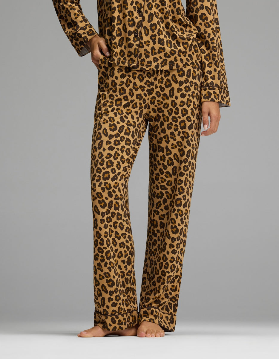 A person wearing loose-fitting Women’s Bamboo Stretch-Knit Pajama Pant in a brown and black leopard print.
