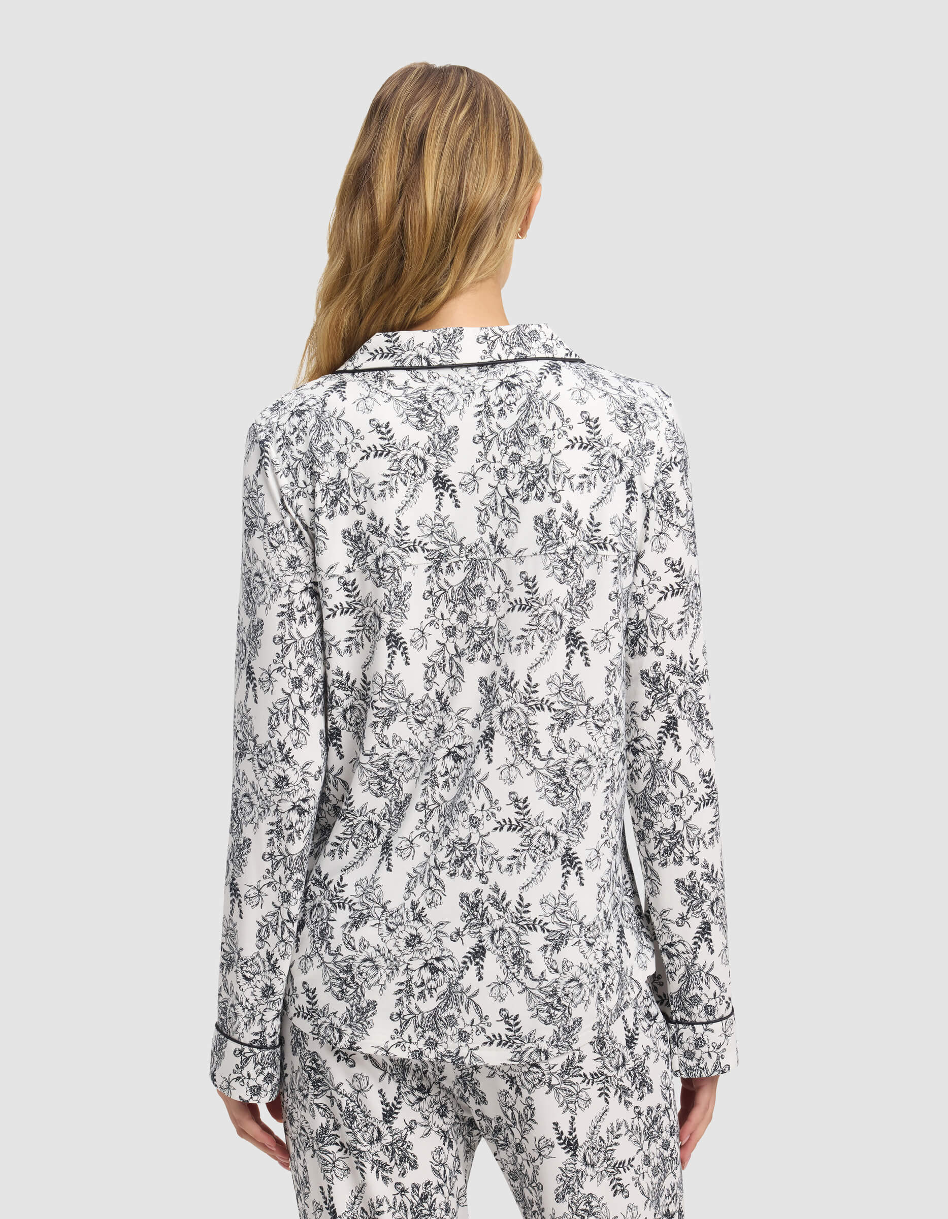 A woman wearing a Cozy Earth Women's Bamboo Stretch-Knit Long Sleeve Pajama Top in white and black.|Color:Jet Black Toile