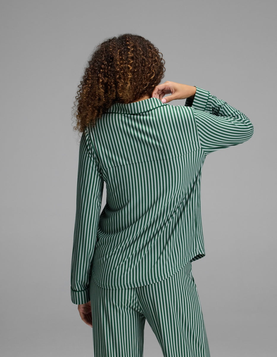 Back view of a person wearing a green-and-white striped Cozy Earth Women’s Bamboo Stretch-Knit Long Sleeve Pajama Top with a collar.