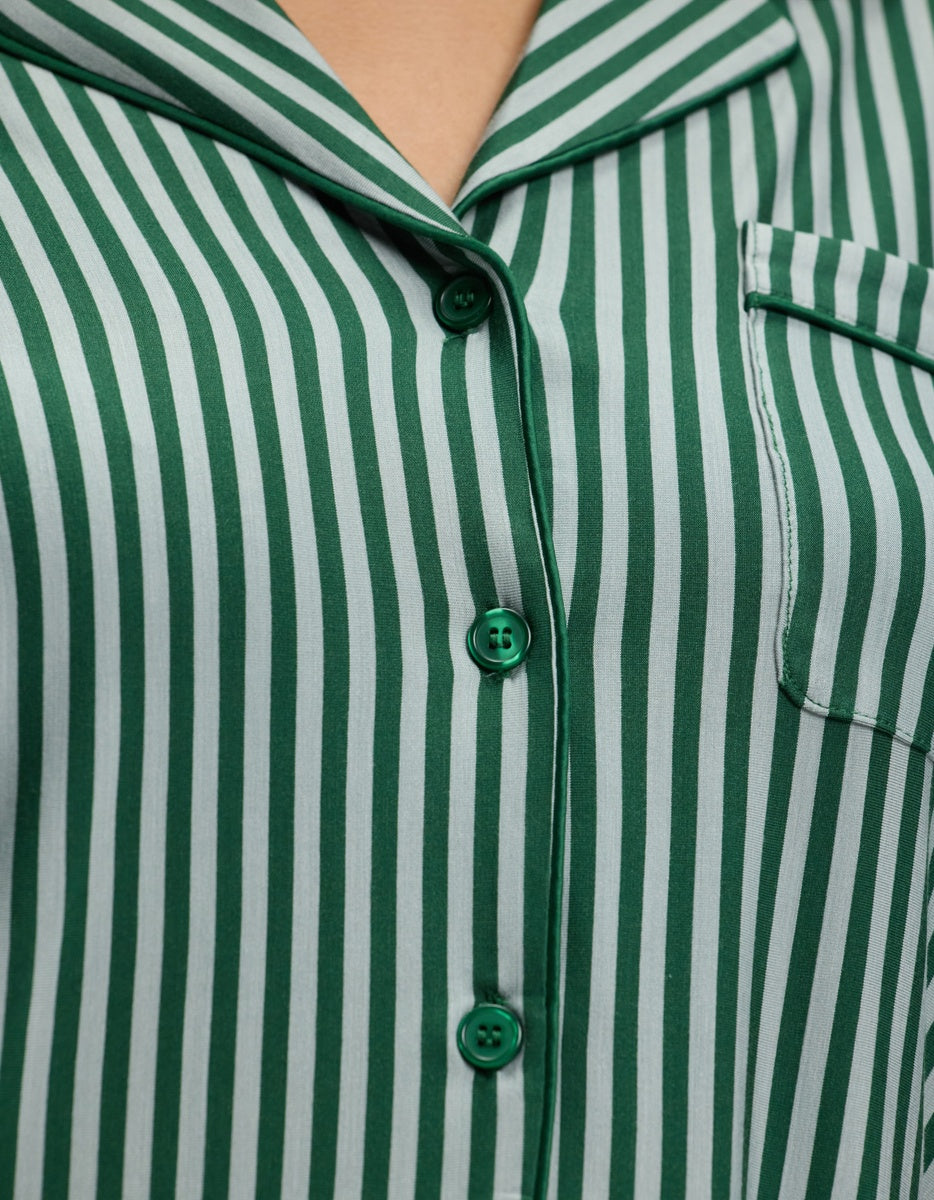 Close-up of a Cozy Earth Women’s Bamboo Stretch-Knit Long Sleeve Pajama Top, featuring a green and white vertical striped pattern, a notched collar, and a breast pocket with green piping.