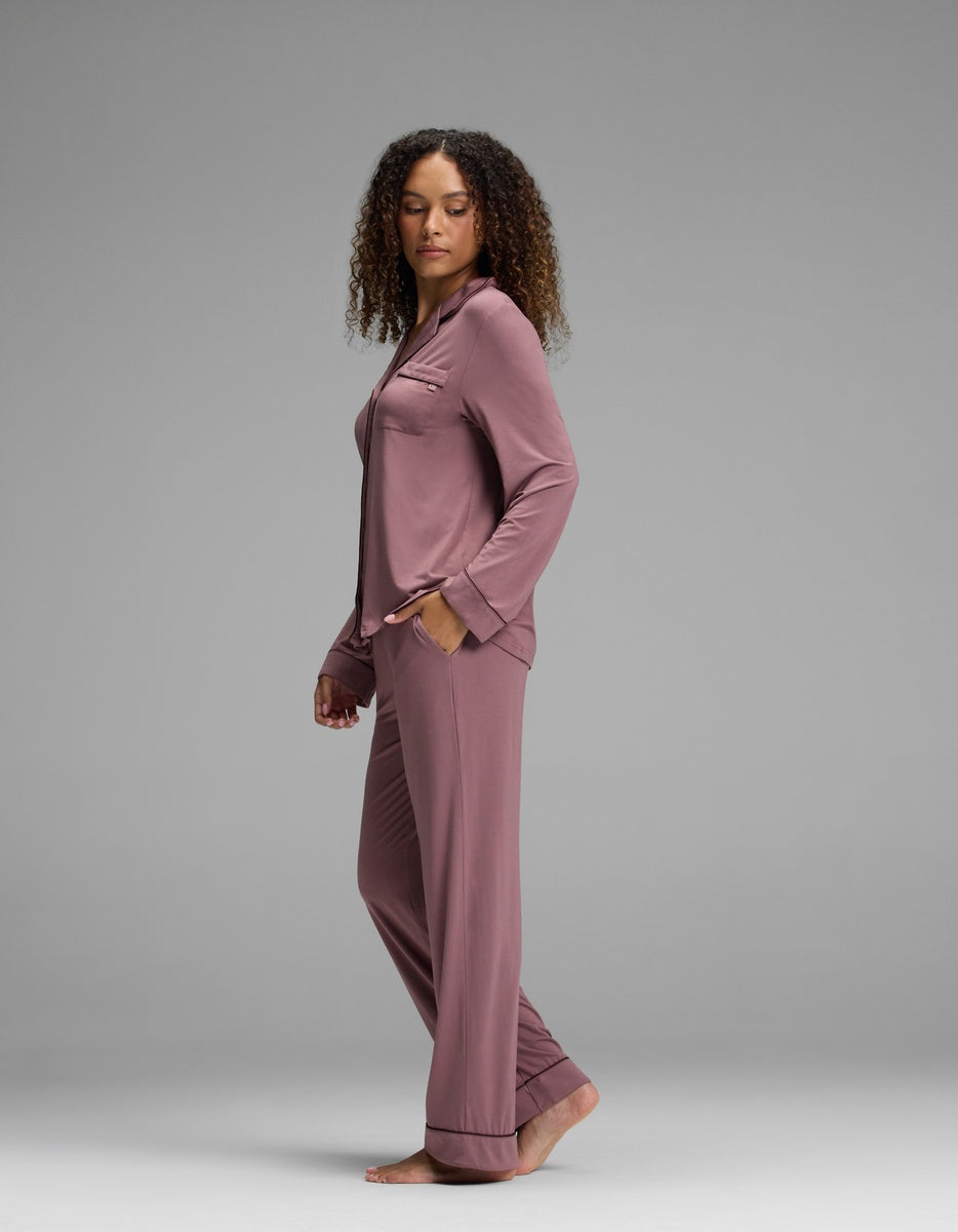 A person wearing a dusty mauve Women’s Bamboo Stretch-Knit Long Sleeve Pajama Set, featuring a button-down shirt and matching trousers.|Color:Copper Rose