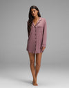 A woman wearing a mauve Cozy Earth Women’s Bamboo Stretch-Knit Long Sleeve Sleep Dress featuring a button-down front, notched collar, and chest pocket.|Color:Copper Rose