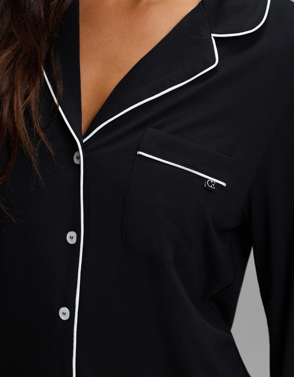 Cozy Earth Women’s Bamboo Stretch-Knit Long Sleeve Sleep Dress in black with white piping, a button-down front, and a chest pocket.