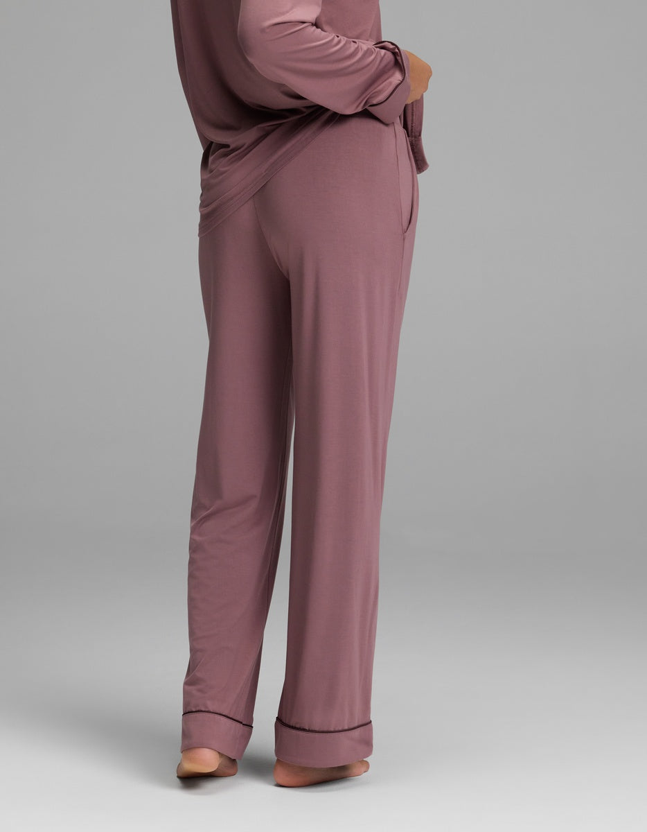 A person from behind wearing mauve long-sleeved pajamas featuring Women’s Bamboo Stretch-Knit Pajama Pant with cuffed hems.