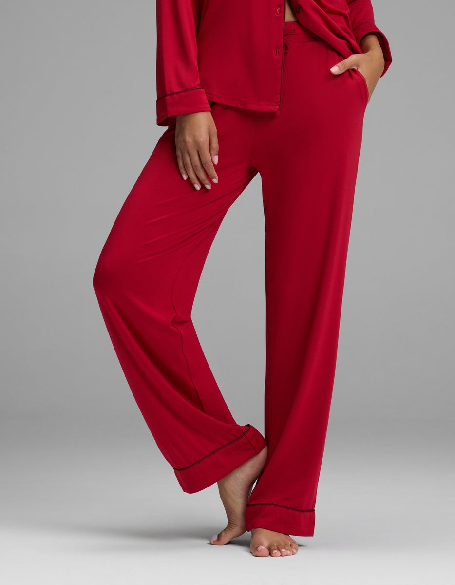 Cozy Earth Women’s Bamboo Stretch-Knit Pajama Pant featuring red pants, a button-front top, and thin dark piping along the edges.