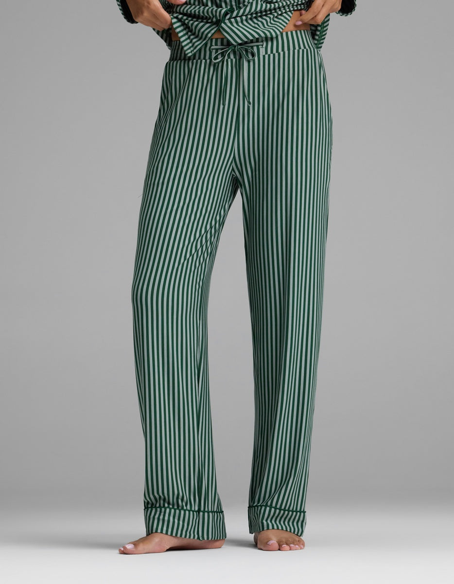 Cozy Earth Women’s Bamboo Stretch-Knit Pajama Pant featuring dark and light green vertical stripes, an elastic drawstring waist, and cuffed hems.