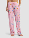 A person stands barefoot, showing only their lower torso and legs, wearing Cozy Earth Women's Bamboo Stretch-Knit Pajama Pant in light pink with colorful heart-shaped designs, featuring a drawstring waist and side pockets.|Color:Primrose Sleepy Hearts