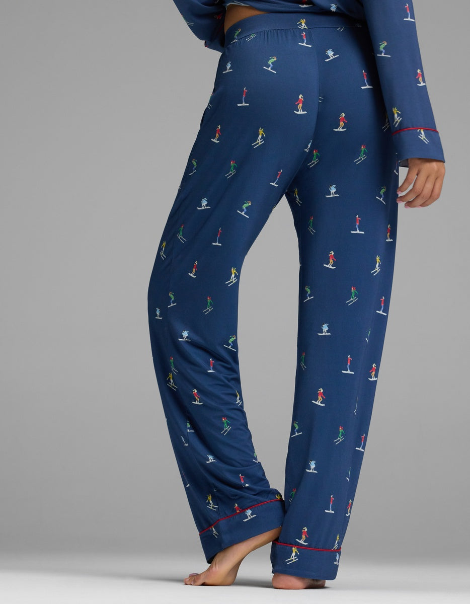 Cozy Earth Women’s Bamboo Stretch-Knit Pajama Pant in navy blue with a repeating pattern of small figures skiing.