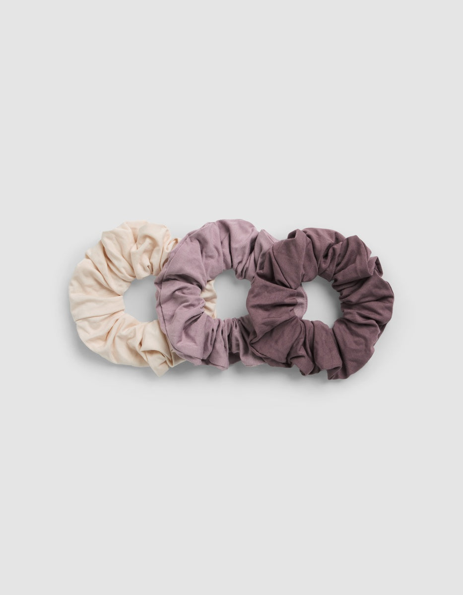 Three Cozy Earth Bamboo Stretch-Knit Scrunchies in shades of cream, mauve, and plum arranged in a row.|Color:Copper Rose/Lilac/Sea Salt