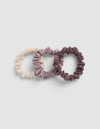 Three Cozy Earth Bamboo Stretch Knit Skinny Scrunchies in cream, mauve, and dark purple arranged in a row.|Color:Copper Rose/Lilac/Sea Salt