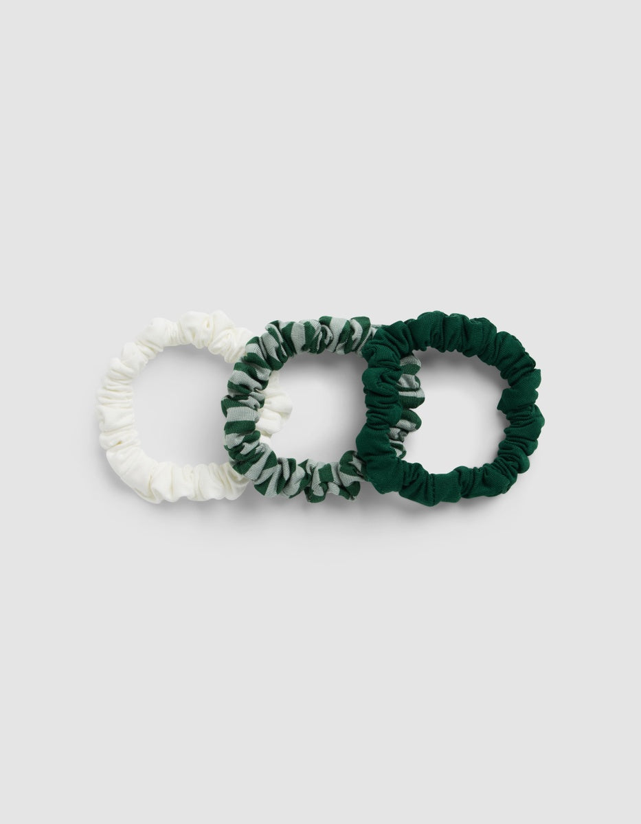 Three Bamboo Stretch-Knit Skinny Scrunchies in Evergreen, Evergreen Stripe, and Sea Salt.