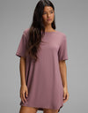 A woman wearing a mauve short-sleeved Cozy Earth Women’s Bamboo Stretch-Knit Sleep Dress.|Color:Copper Rose