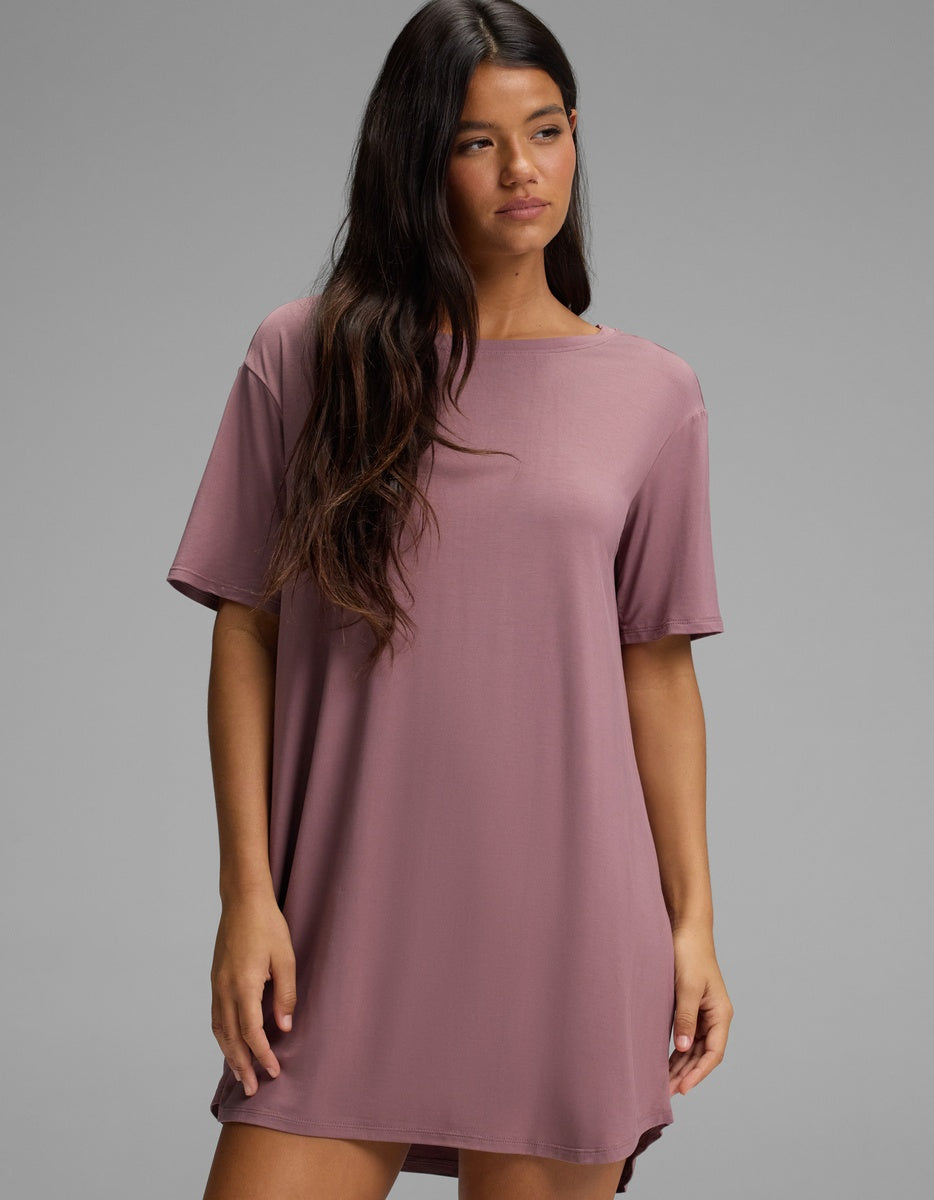 A woman wearing a mauve short-sleeved Cozy Earth Women’s Bamboo Stretch-Knit Sleep Dress.