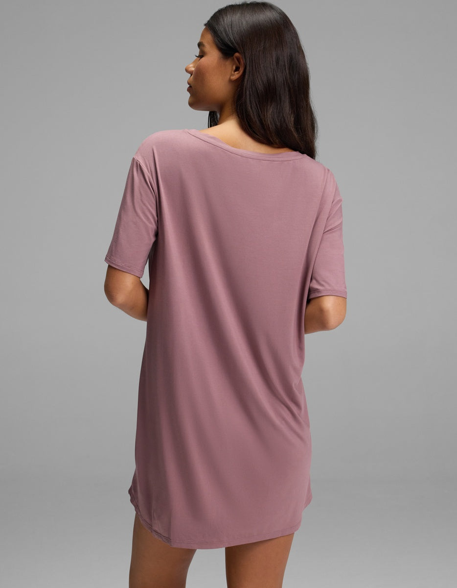 A person viewed from behind wearing a mauve, short-sleeved Cozy Earth Women’s Bamboo Stretch-Knit Sleep Dress.