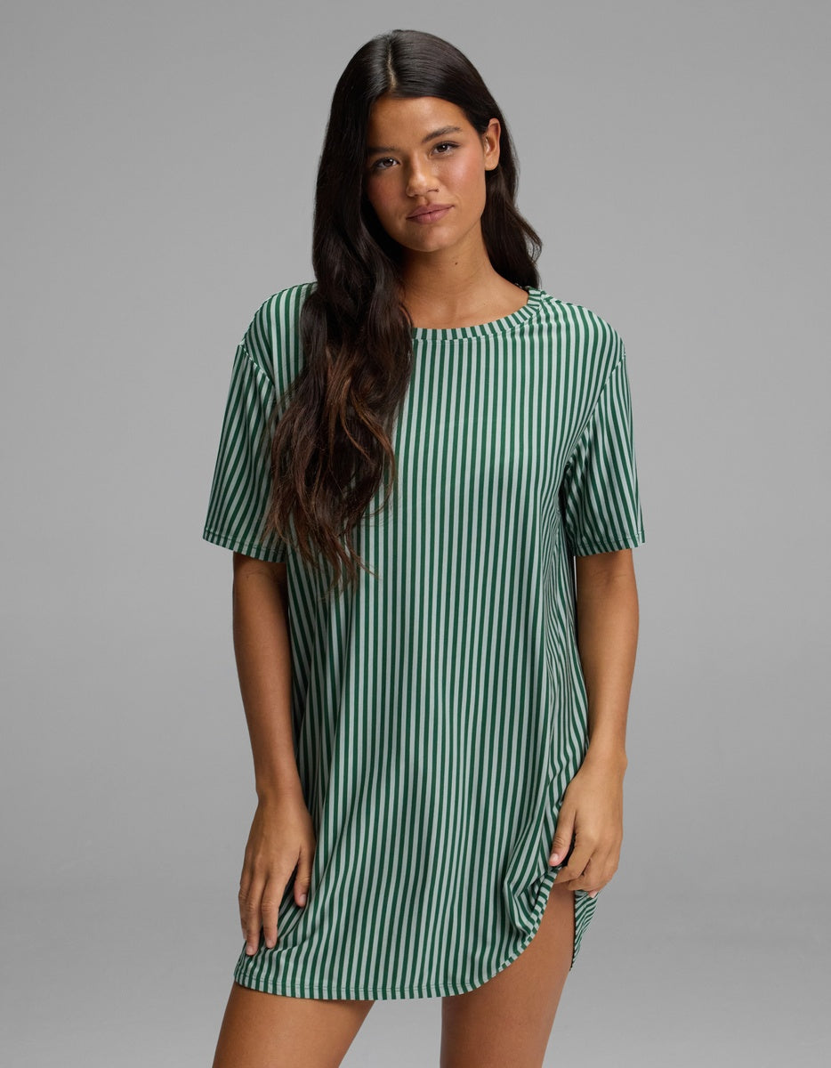 A woman wears a green and white vertical-striped short-sleeve Women’s Bamboo Stretch-Knit Sleep Dress.