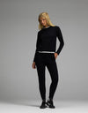 A woman with long blonde hair wears the Cozy Earth Women’s Brushed Bamboo Jogger Set in black, standing against a plain gray background.|Color:Black