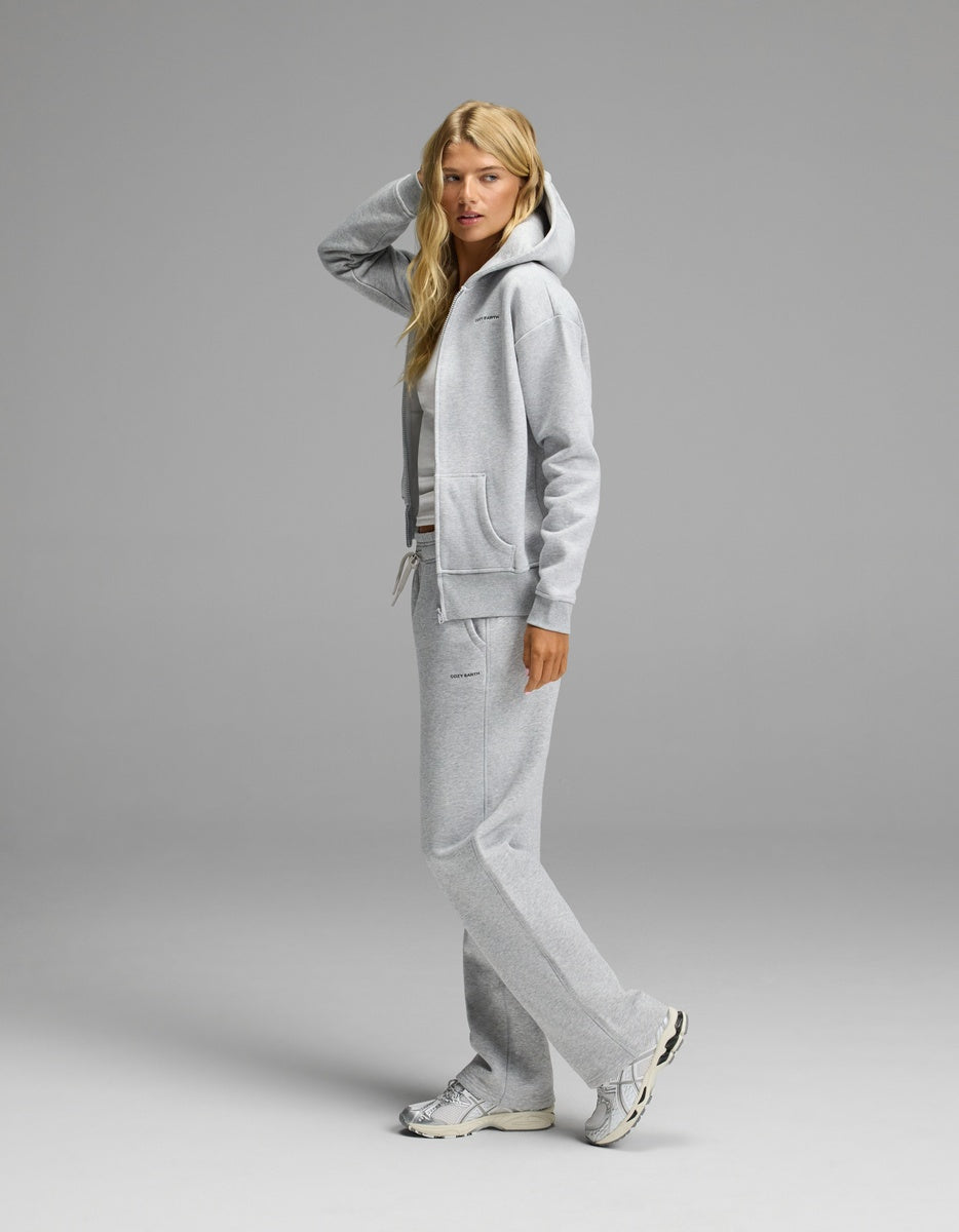 A woman in profile wearing a gray Cozy Earth Women’s Cityscape Full-Zip Hoodie & Wide Leg Pant Set, featuring a hooded zip-up sweatshirt and matching wide-leg sweatpants.