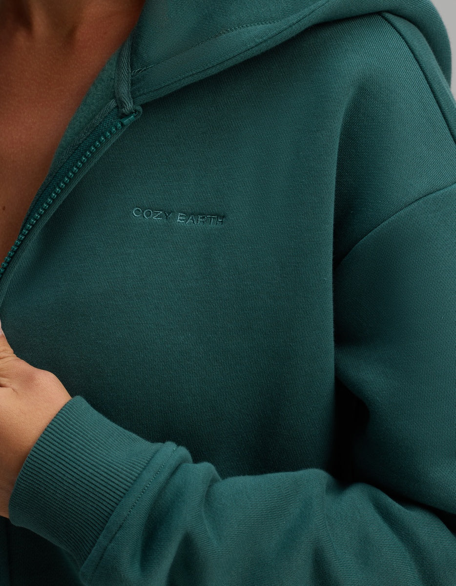 Dark green Cozy Earth Women’s CityScape Full-Zip Hoodie with the brand name embroidered in matching thread on the chest.