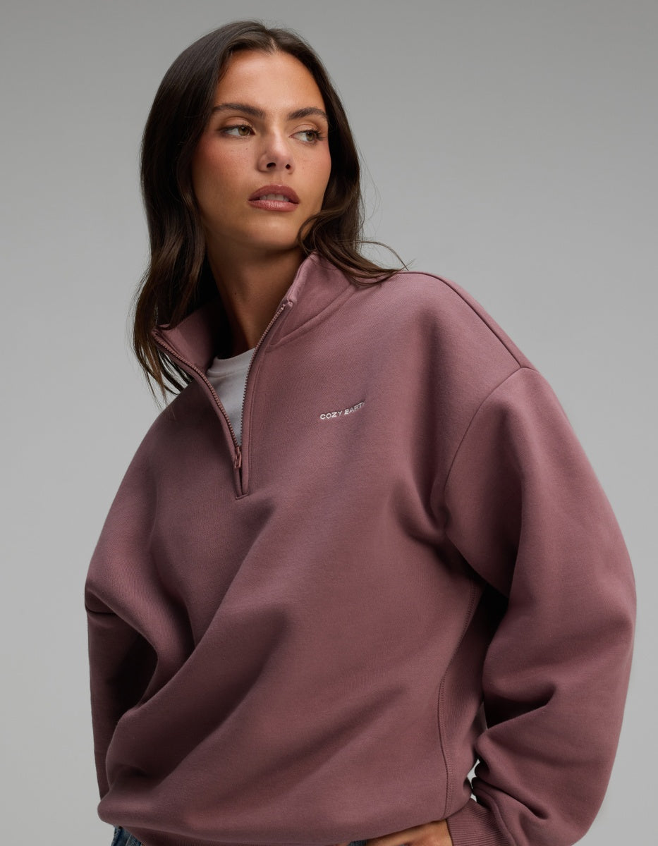 A person wearing a dusty rose-colored Cozy Earth Women’s CityScape Quarter Zip sweatshirt.|Color:Copper Rose