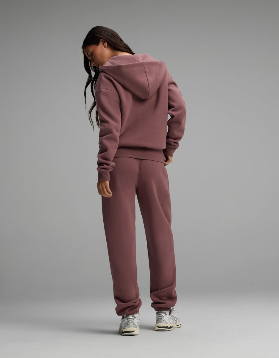 A woman wearing a mauve Women’s Cityscape Full-Zip Hoodie & Sweatpant Set.